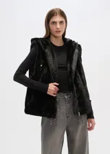 Chaleco negro de piel sintética con capucha, cierre frontal con cremallera y bolsillos laterales.