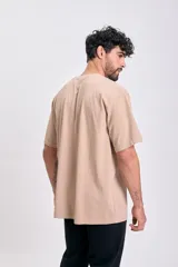 Remera manga corta color beige, corte oversize, con estampa frontal "BOLD GRAPHIC" en marrón.