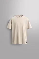 Camiseta color beige de corte holgado, cuello redondo y manga corta.