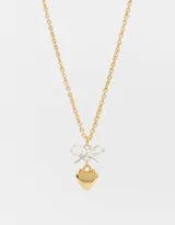 Cadena corta dorada con dije de moño plateado y corazón dorado.