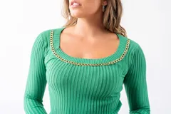 Buzo corto verde de tejido de punto acanalado, con escote redondo adornado con una cadena dorada.
