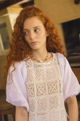 Blusa blanca con cuerpo de encaje de crochet cuadrillé y mangas abuchonadas de lino.