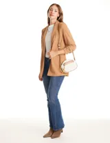 Cartera tipo bandolera de eco cuero con silueta de media luna, color beige y detalles en marrón claro. Incluye un monedero/tarjetero independiente en el bolsillo frontal y una cadena decorativa de eslabones dorados.