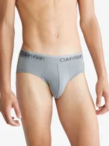 Pack de tres slips negros de algodón con cinturilla elástica con logo Calvin Klein en blanco, negro y rojo.