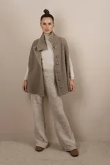 Capa marrón de lana con cuello alto abotonado y aberturas laterales.