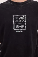 Remera negra con efecto gastado, corte amplio y estampado blanco en el pecho con motivos playeros.