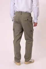 Pantalón cargo color beige con bolsillos laterales con solapa y cierre de botón a presión.