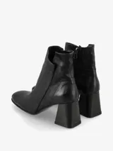 Botín de cuero color marrón oscuro con tacón cuadrado y cierre lateral.