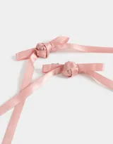 Set de dos hebillas para el pelo, con lazos de satén color rosa claro y detalle de flor en el centro.