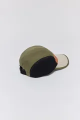 Gorra de visera de cinco paneles con diseño color block en verde oliva, naranja, beige y negro.