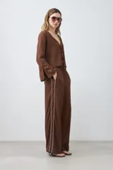 Pantalón de lino color chocolate, de corte palazzo, con cintura elastizada y vivo blanco en los laterales.