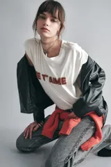 Remera blanca de algodón con mangas cortas, calce relajado y escote redondo. Presenta un bordado frontal con canutillos formando la frase "Je t'aime".