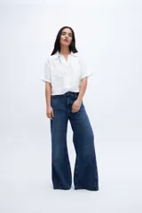Blusa verde con escote en V, cuello camisero, manga corta y dos bolsillos en el pecho.