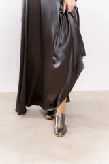 Zapatillas deportivas plateadas con detalles en blanco y suela de goma color caramelo.