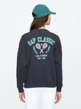 Buzo deportivo azul con cuello redondo, puños y ruedo acanalados. Estampado frontal con el logo de Gap Athletic en color celeste.