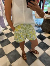 Short de tela con estampado floral en tonos verdes y amarillos, de corte cómodo.