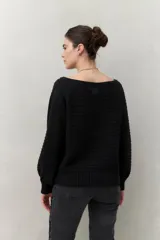 Sweater negro tramado de silueta relajada, con combinación de texturas en el tejido y mangas abullonadas con puños elastizados.