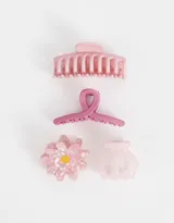 Set de cuatro broches para el pelo de diferentes tamaños y formas en tonos rosados. Incluye un broche tipo pinza, un broche con forma de moño, un broche con forma de flor y un broche pequeño tipo pinza.