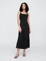 Vestido midi negro con breteles finos y corte ajustado.