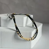 Pulsera doble ajustable en hilo negro y acero enchapado en oro con mostacillas miyuki.