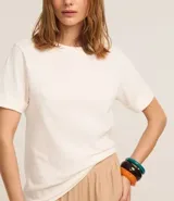 Remera de malla color blanco, de corte recto y mangas cortas con dobladillo.