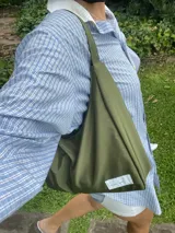 Cartera tipo baguette negra de lona semi impermeable con cierre metálico y forrería de gross con bolsillo interno.