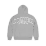 Campera gris con capucha y cierre frontal, con el logo de la marca Corteiz estampado en la espalda.
