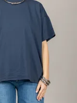 Remera blanca amplia de manga corta con cuello redondo.