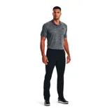 Remera polo Under Armour Matchplay para hombre, color gris jaspeado con logo negro en el pecho.