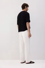 Pantalón blanco de lino con corte recto, cintura elástica y cordón ajustable.
