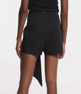 Short pollera corto color negro, confeccionado en crepé con cierre en la espalda y cinta lateral.