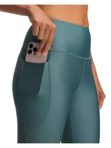 Calza deportiva Under Armour HeatGear Ankle Leggings, color azul verdoso, con cintura alta y bolsillo lateral.