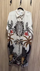 Vestido camisero corto color blanco con estampado de palmeras, flores y ananás.