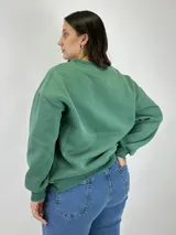 Buzo verde con estampado frontal que dice 'California Los Angeles' y ajuste holgado.