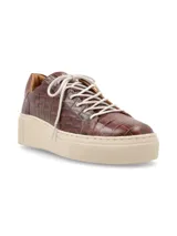 Sneakers de cuero graneado color verde oliva con suela elevada color crema y cordones de algodón.