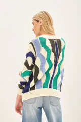 Sweater de punto con tejido desagujado y recortes asimétricos. Detalles de rib en escote, mangas y cuello.