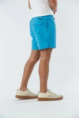 Short de baño celeste liso, con cintura elástica ajustable con cordón negro, dos bolsillos delanteros y uno trasero.