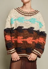 Sweater de lana tejido a mano con diseño abstracto en tonos beige, marrón, naranja, celeste y negro. De calce holgado, con cuello redondo y puños acanalados.