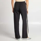 Pantalón negro de tiro alto con corte ancho, cintura elastizada con cordón ajustable y bandas laterales en color crudo.