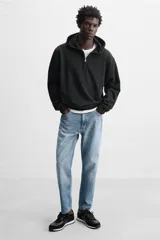 Zapatilla deportiva negra con detalles en piel y acabado serraje.