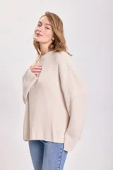 Sweater color crudo de punto inglés con cuello redondo y mangas largas.