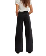 Pantalón de denim negro de tiro alto, corte ancho y pierna recta. Presenta costuras verticales marcadas en el frente y cierre de botones.