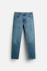 Pantalón de jean azul oscuro, corte slim fit, tiro medio, cinco bolsillos, tejido elástico y efecto lavado.