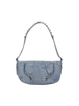 Bolso de hombro azul denim con tachuelas plateadas en el cuerpo y el asa.