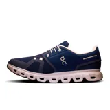 Championes de running azules con detalles en blanco y logo de la marca en el lateral.