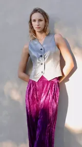 Pantalón de terciopelo color fucsia, de corte palazzo, con bolsillos laterales, pinzas frontales y cintura elástica.