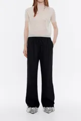 Pantalón largo negro de lino, corte jogger, con cintura ajustable con cordones y bolsillos laterales.