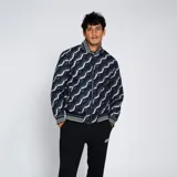 Campera bomber reversible con estampado geométrico en tonos azules y verde neón.