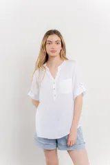 Camisa azul de lino con escote en V abotonado, bolsillo frontal y mangas 3/4 con trabilla.