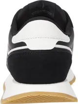 Zapatillas Tommy Jeans negras con detalles en blanco y suela color caramelo. Presentan paneles de cuero y gamuza, cordones negros y logo de la marca en el lateral.